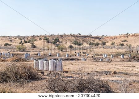 The dry Auob River south of Gochas being cleared by burning invader shrubs and trees to produce charcoal