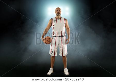 Caucassian Basketball Player in dynamic action with ball in a professional sport game