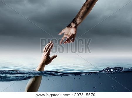 Hand of person drowning in water