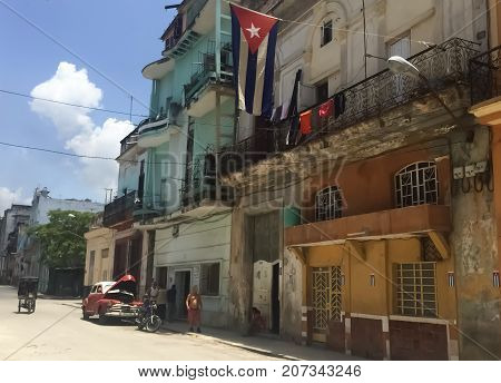 Street in Havana with car and flag