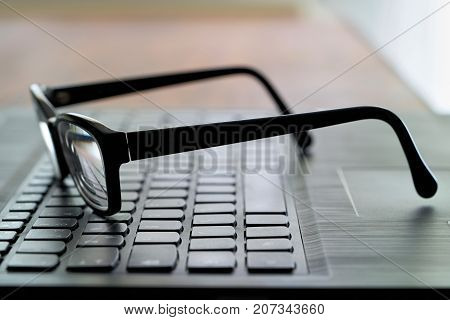 Glasses on the computer keyboard during a break