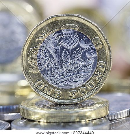 Close up of a British one pound coin in a square format.