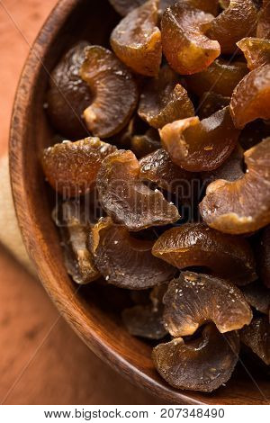 Ayurvedic Amla Candy, which is dried and salty-sweet or chatpata in taste and digestive. Served in a wooden bowl, selective focus