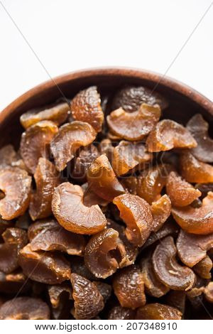 Ayurvedic Amla Candy, which is dried and salty-sweet or chatpata in taste and digestive. Served in a wooden bowl, selective focus