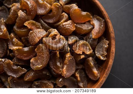Ayurvedic Amla Candy, which is dried and salty-sweet or chatpata in taste and digestive. Served in a wooden bowl, selective focus