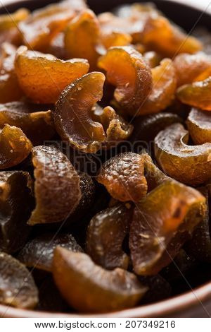 Ayurvedic Amla Candy, which is dried and salty-sweet or chatpata in taste and digestive. Served in a wooden bowl, selective focus