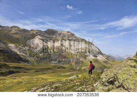 Female hiker admiring the landscape from the center of the glacial Circus of Troumouse one of the largest from the Europe.