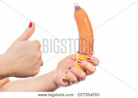 Woman holding banana with condom isolated on white background. Masturbation Man Penis Erection Condom Satisfaction Sex Woman Hand Concept.