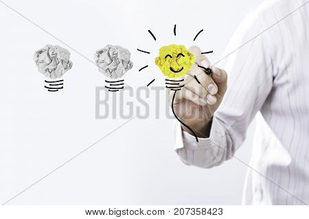 Businessman hand drawing yellow light bulb Creative concept.