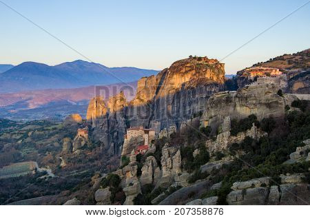 Breathtaking view of Meteora at sunset, Greece. Geological formations of big rocks with Monasteries on top of them.