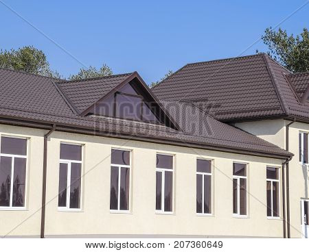 House With Plastic Windows And Roof Of Corrugated Sheet. Roofing Of Metal Profile Wavy Shape On The