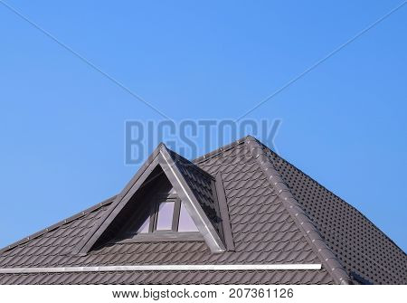 House With Plastic Windows And A Brown Roof Of Corrugated Sheet