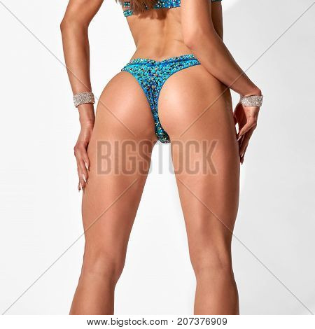 Closeup photo of fit sexy part female buttocks on white background