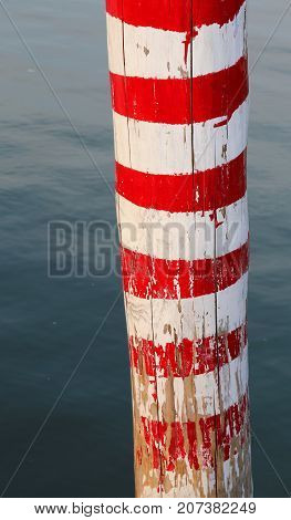 Red And White Pole On The Sea