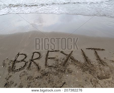Text Brexit On The Sand Of The Sea Waiting To Be Erased By The W