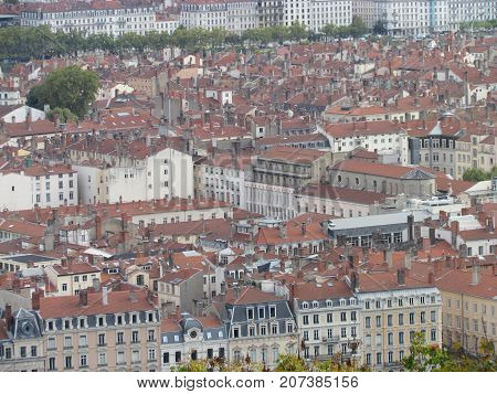 Aerial view of a cityscpae of downtown Lyon in France with plenty of red roofs and white old buildings