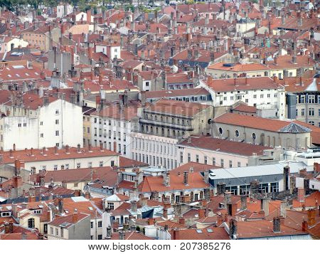 Aerial view of a cityscpae of downtown Lyon in France with plenty of red roofs and white old buildings