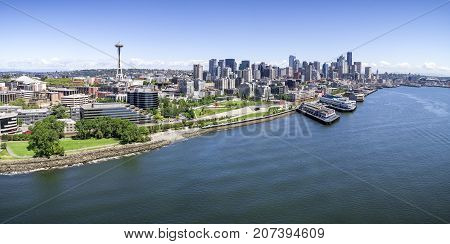 Aerial drone perspective with birds eye view on Elliot Bay with Puget Sound ocean water and city skyline of downtown skyscraper buildings in Pacific Northwest