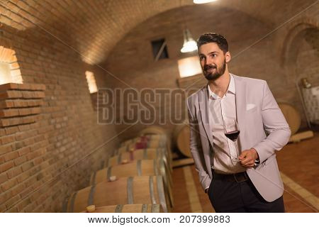 Oenologist tasting wines in wine grower cellar