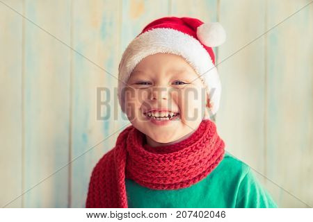 Smiling boy in red cap of Santa Claus