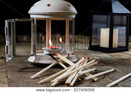 Two Small Lanterns On A Wooden Table. Candle In Old Latarence. Wooden Table.