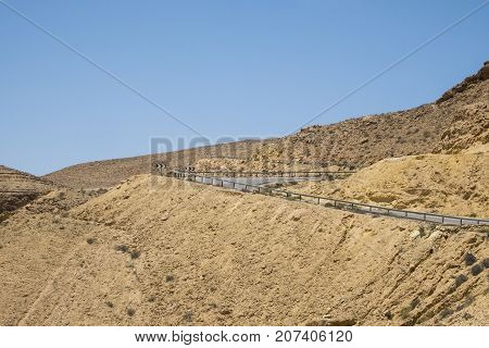 Serpentine road in the desert Negev descending into a large crater Ha-Gadol (Israel)