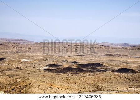 The large crater Ha-Makhtesh Ha-Gadol near Yeruham and the road leading to the colored sands (Israel)