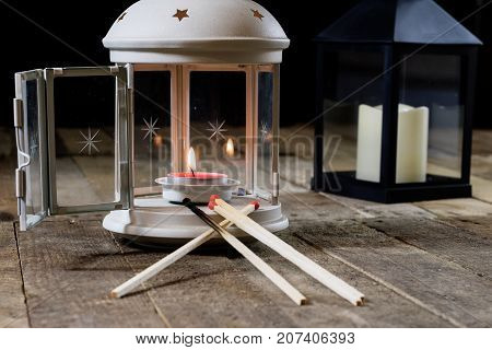 Two Small Lanterns On A Wooden Table. Candle In Old Latarence. Wooden Table.