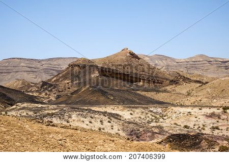 The mountain along the crater of Ha-Gadol and the black stones covering the surface (Israel)
