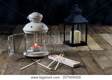 Two Small Lanterns On A Wooden Table. Candle In Old Latarence. Wooden Table.