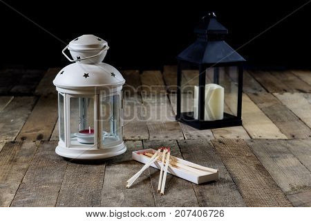 Two Small Lanterns On A Wooden Table. Candle In Old Latarence. Wooden Table.