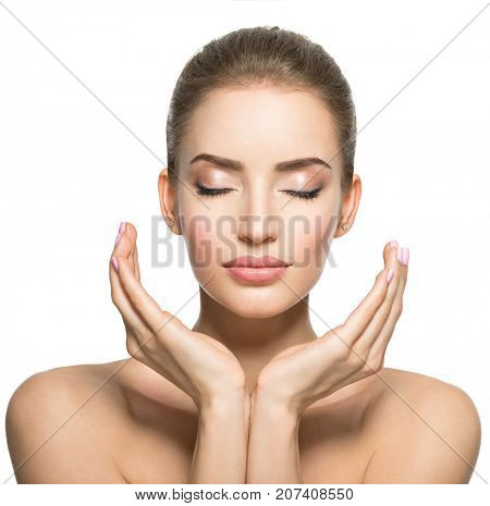 Beautiful face of young caucasian woman with  health skin  - isolated on white.  Skin care concept. Female Model touches face.