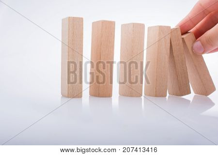 Hand Holding Wooden Domino