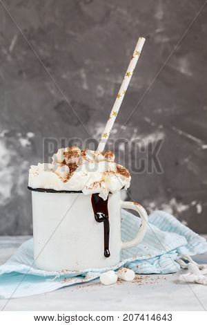 christmas background: cocoa with cream and cinnamon on a concrete background