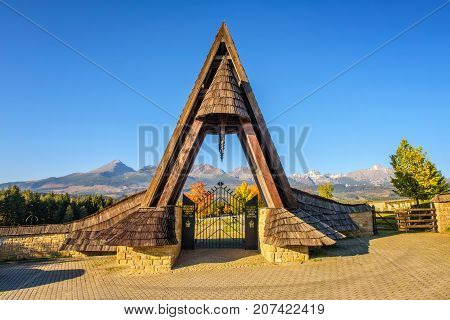 VAZEC, SLOVAKA - OCTOBER 1, 2017 : Entry gate of the german military cemetery in autumn with High Tatra mountains in the background.