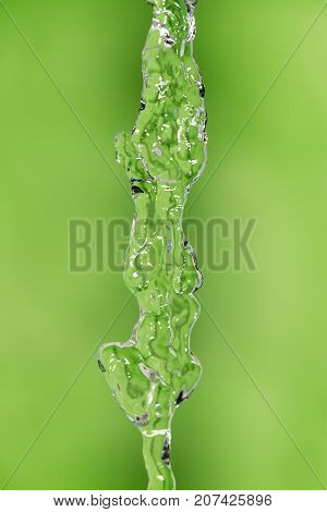 a jet of water on a green background