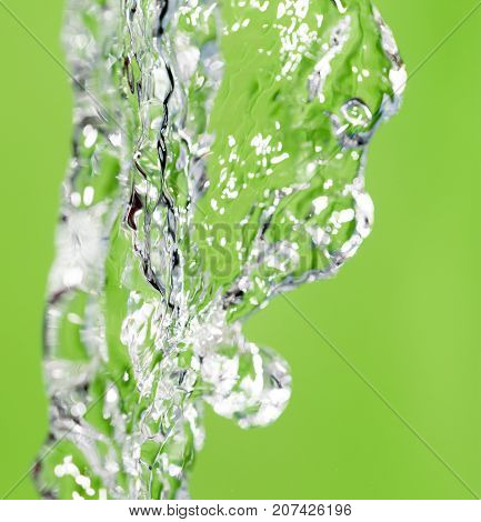 a jet of water on a green background