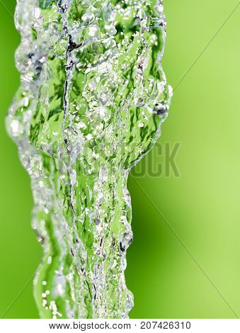 a jet of water on a green background