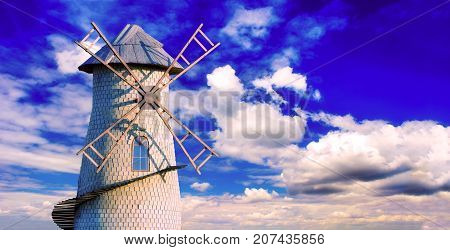 Old windmill on the background of a cloudy sky. Space for text.