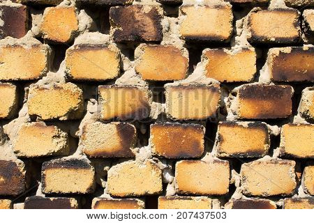 The old brickwork of the old building is made of yellow brick.
