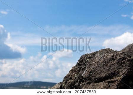 Clouds in the background with rocks rocks in the foreground.