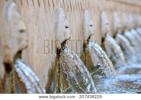 Old venetian fountain with lion heads springs pure drinking water in Spili Crete island Greece