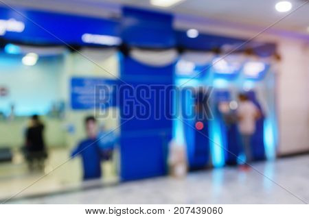 blurred image of people queuing to withdraw money from ATM (Automated Teller Machine) e-banking finance payment and shopping online concept