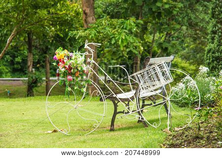 Old white bicycle in the park placed beside the field chair.Relaxation