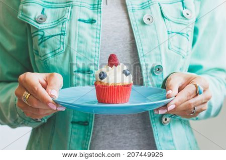 Woman With A Cupcake On The Palte