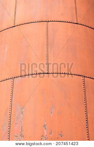 The skin of an old rusty blast furnace at an factory.
