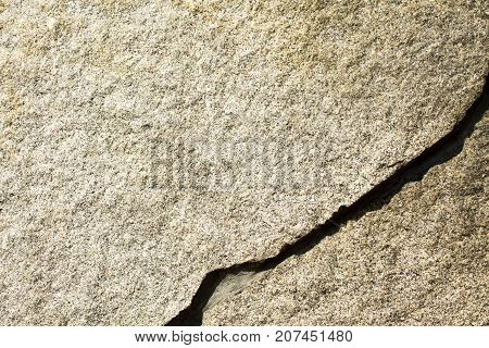 The granite surface of the wall is light brown in color.