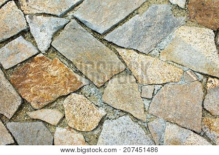 Masonry track made of yellow and brown large stones.