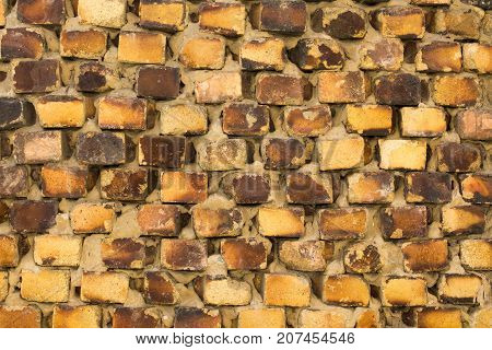 The old brickwork of the old building is made of yellow brick.