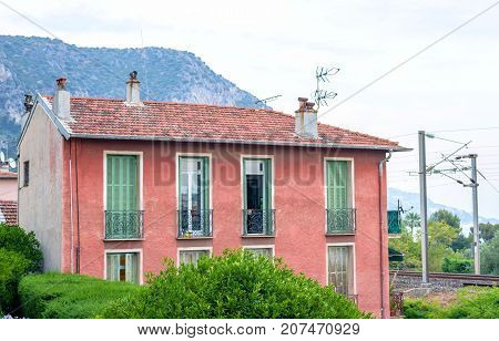 Beautiful sunset view to a red old house or apartments in Beaulieu sur mer, France